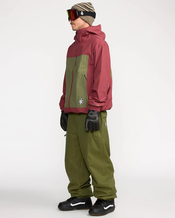 Image of a model wearing Pants. Product name - Volcom Mens Arthur 20K Snow Pants Dark Olive in Dark Olive colour by brand - Volcom