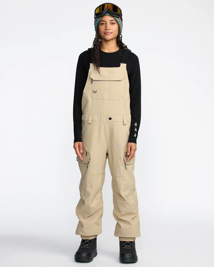 Image of a model wearing Pants. Product name - Volcom Womens Creston 3D Stretch Bib Overall Oatmeal in Oatmeal colour by brand - Volcom