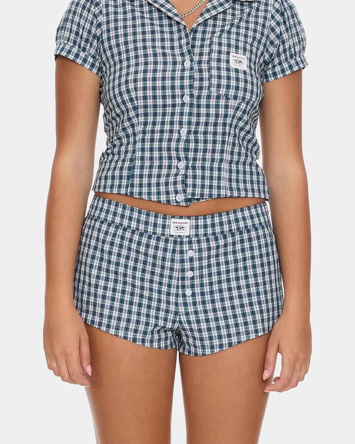 Image of a model wearing Shorts. Productname: worship - Womens Checkmate Micro Boxer Walkshorts - Blue - in Blue colour by brand - worship