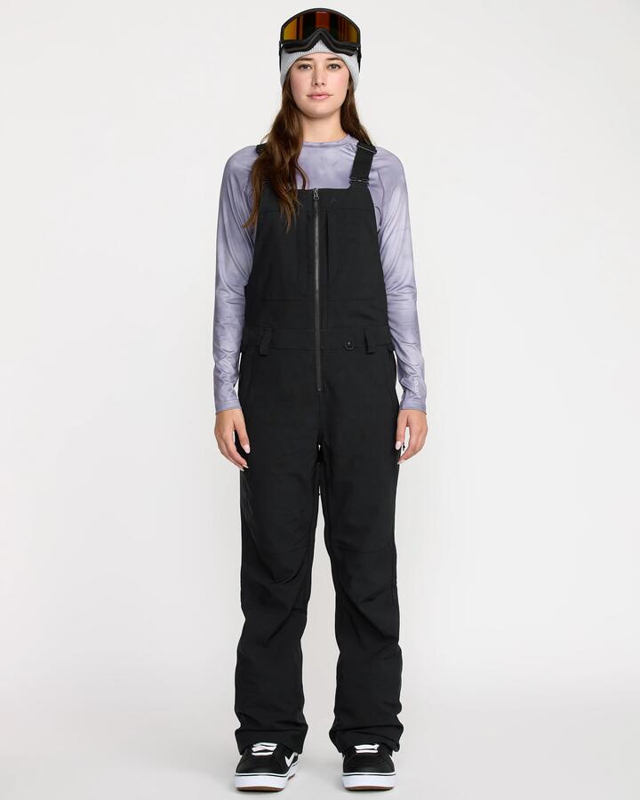 Image of a model wearing Pants. Product name - Volcom Womens Swift Bib Snow Pants Black in Black colour by brand - Volcom