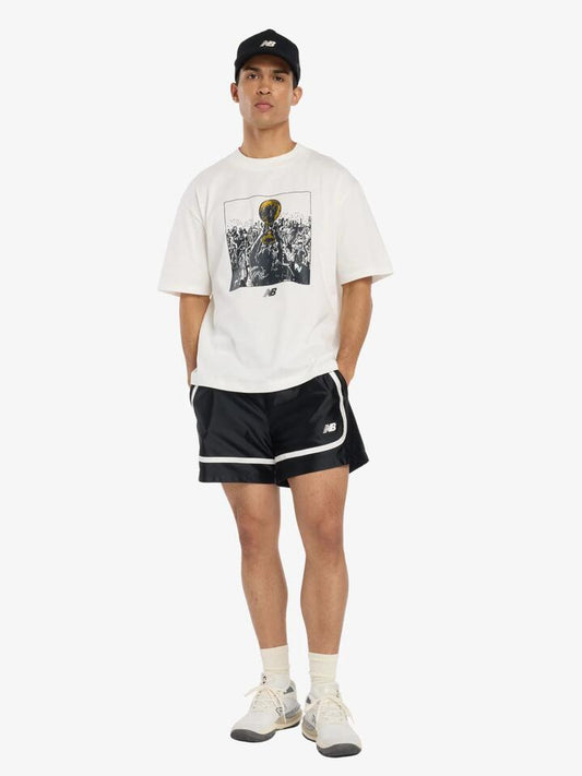 Image of a model wearing Tops. Productname: New Balance Hoops Championship Graphic T-Shirt in Sea Salt colour by brand - New Balance