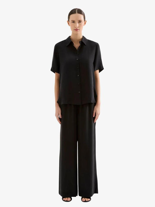 Image of a model wearing Tops. Productname: Nude Lucy Dara Cupro Shirt in Black colour by brand - Nude Lucy