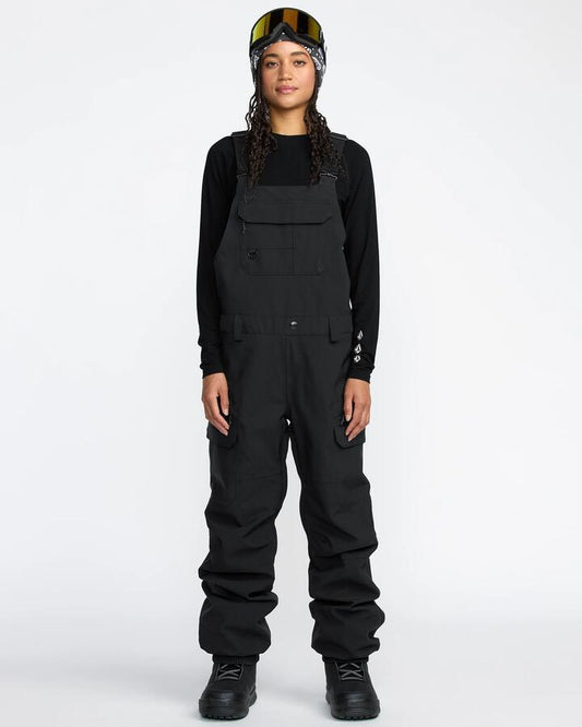 Image of a model wearing Pants. Productname: Volcom - Womens Creston 3D Stretch Bib Overall - Black - in Black colour by brand - Volcom