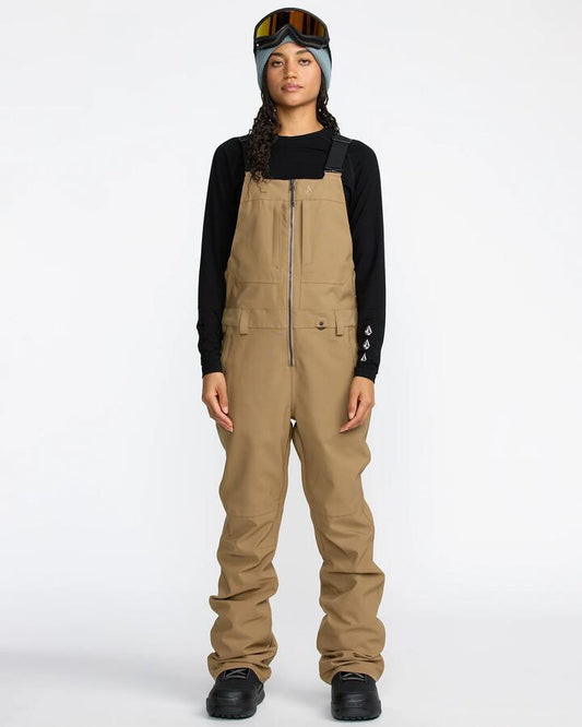 Image of a model wearing Pants. Productname: Volcom - Womens Swift Bib Snow Pants - Bronze - in Bronze colour by brand - Volcom