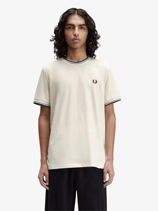 Image of a model wearing Tops. Productname: Fred Perry Twin Tipped T-Shirt in Ecru Court Blue Oxblood colour by brand - Fred Perry