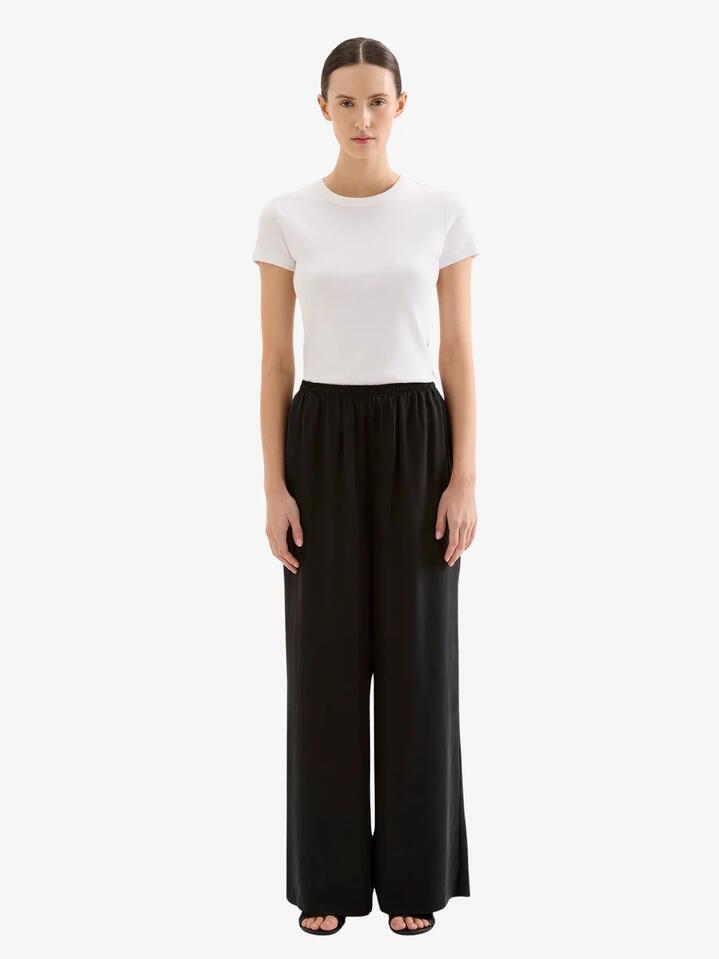 Image of a model wearing Pants. Productname: Nude Lucy Dara Cupro Pant in Black colour by brand - Nude Lucy