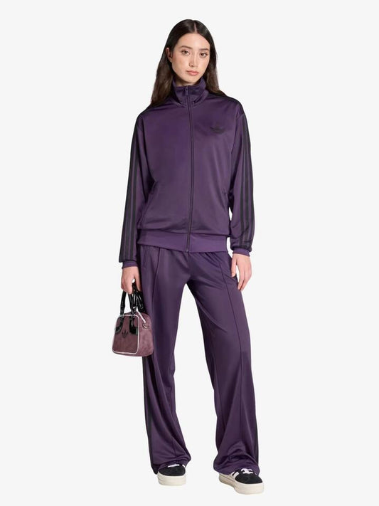 Image of a model wearing Pants. Productname: Adidas Women's Firebird Track Pants in aurora plum/black colour by brand - Adidas