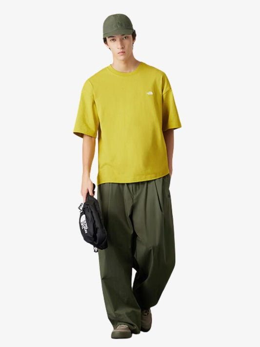 Image of a model wearing Tops. Productname: The North Face M Small Logo SS Tee in Dijon Yellow colour by brand - The North Face