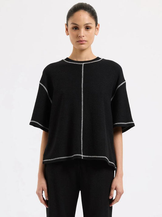 Image of a model wearing Tops. Productname: Nude Lucy Sutton Tee in Black colour by brand - Nude Lucy