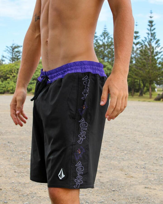 Image of a model wearing Shorts. Productname: Volcom - Mens Featured Artist Ozzy Trunk 21" Swim Shorts - Black - in Black colour by brand - Volcom