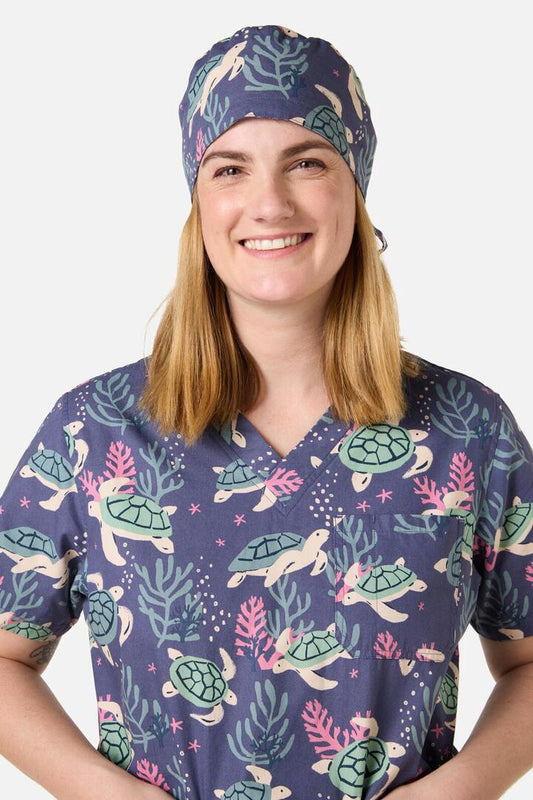 Image of a model wearing Tops. Productname: Sea Turtle Scrub Hat in Blue colour by brand - Scrubs With Love