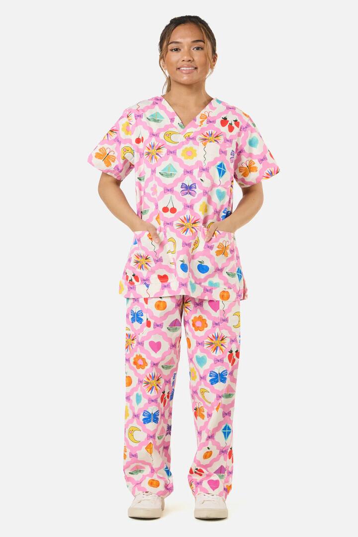 Image of a model wearing Uniforms & Workwear. Product name - Trinkets Scrub Set in Pink colour by brand - Gorman