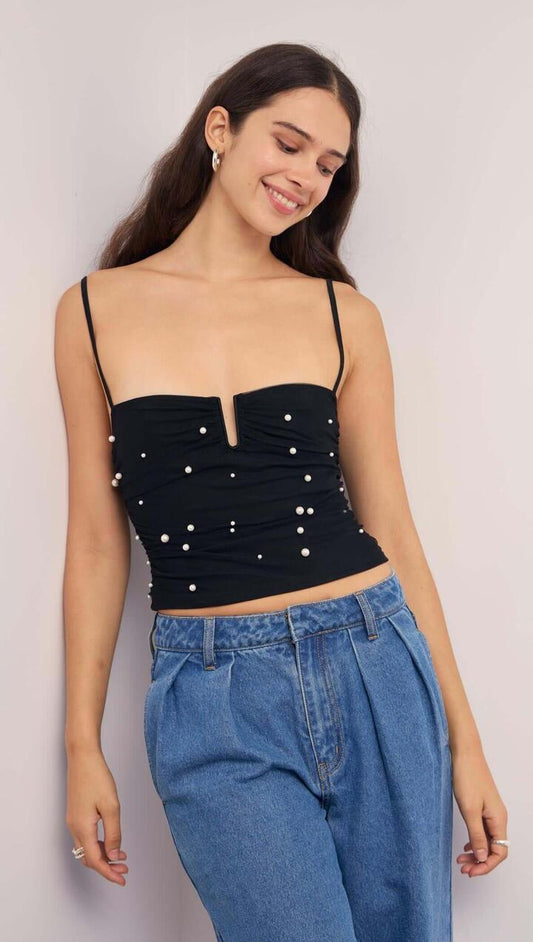 Image of a model wearing Tops. Product name - Pearl Embellished Black Mesh Crop Top in Black/Pearl colour by brand - MINKPINK