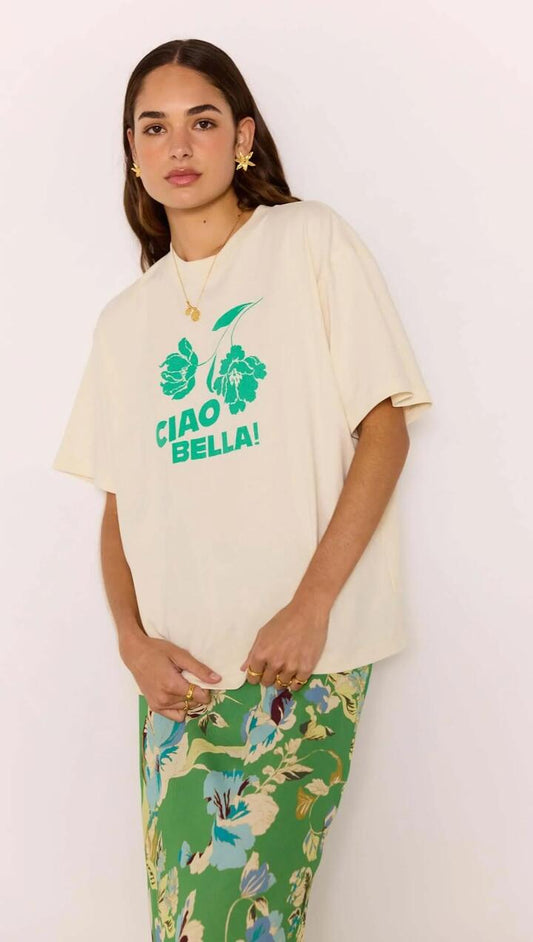 Image of a model wearing Tops. Product name - Ciao Bella Relaxed Cotton Oversized Tee in White/Green colour by brand - MINKPINK