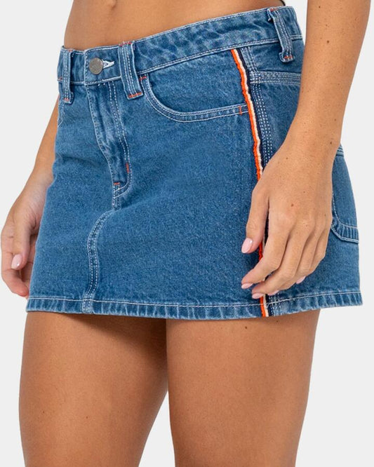 Image of a model wearing Skirts. Productname: rusty Womens Flip Mommy Low Rise Mini Denim Skirt Middy Blue / Orange - in Middy Blue / Orange colour by brand - Rusty