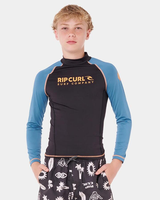 Image of a model wearing Tops. Product name - Rip Curl Boys 8-16 Shock Upf Long Sleeve Rash Vest Storm Blue in Storm Blue colour by brand - Rip Curl