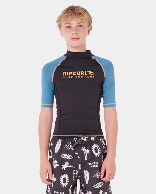 Image of a model wearing Tops. Productname: Rip Curl Boys 8-16 Shock Upf Short Sleeve Rash Vest Storm Blue - in Storm Blue colour by brand - Rip Curl