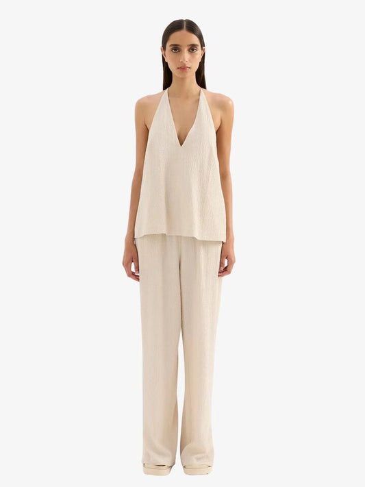 Image of a model wearing Tops. Productname: Nude Lucy Palma Halter Top in Cream colour by brand - Nude Lucy