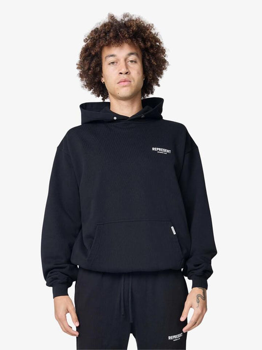Image of a model wearing Outerwear. Productname: Represent Represent Owners Club Hoodie in Aged Black colour by brand - Represent