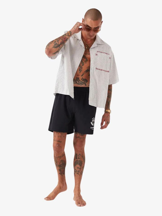 Image of a model wearing Shorts. Productname: Zanerobe Crest Balmoral Beach Shorts in Black colour by brand - Zanerobe