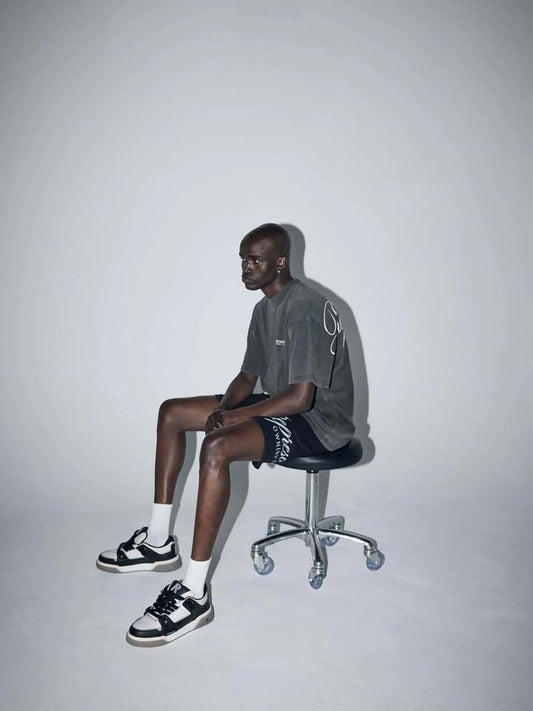 Image of a model wearing Shorts. Productname: Represent Represent Owners Club Script Mesh Shorts in Black colour by brand - Represent