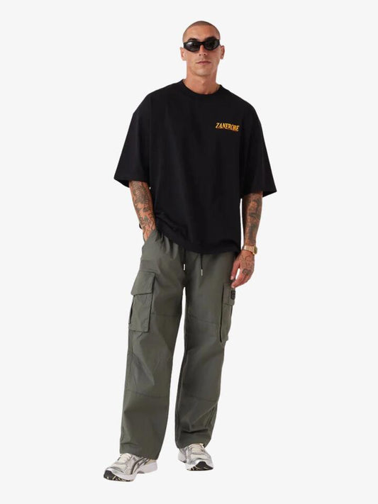 Image of a model wearing Tops. Productname: Zanerobe Portfolio Flow Tee in Black colour by brand - Zanerobe