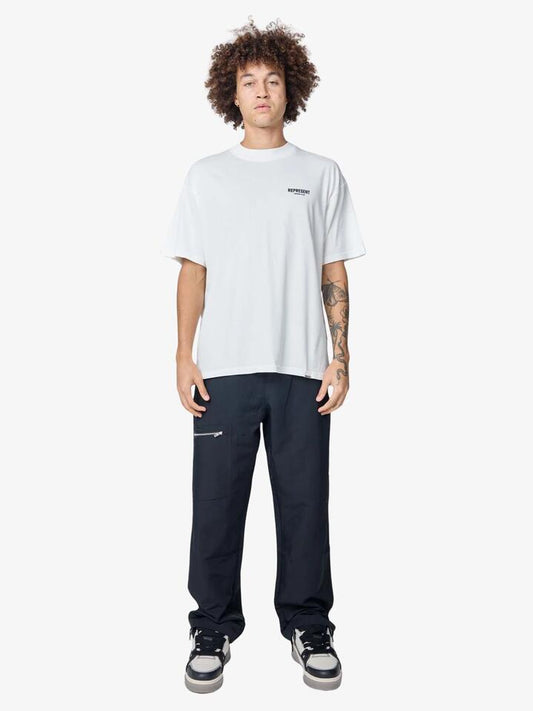 Image of a model wearing Tops. Productname: Represent Represent Owners Club T-Shirt in Flat White colour by brand - Represent