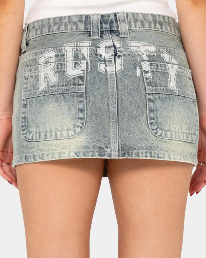 Image of a model wearing Skirts. Productname: rusty - Womens Norty Low Rise Micro Denim Skirt - Dirty - in Dirty colour by brand - rusty