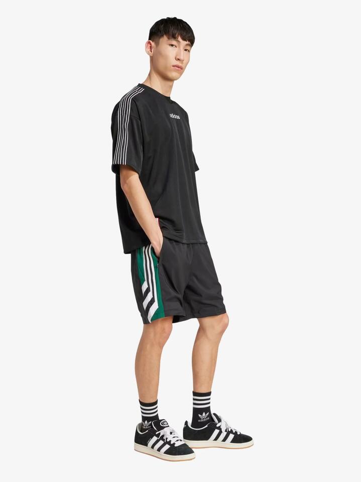 Image of a model wearing Shorts. Productname: Adidas 90s Football Shorts in Black colour by brand - Adidas