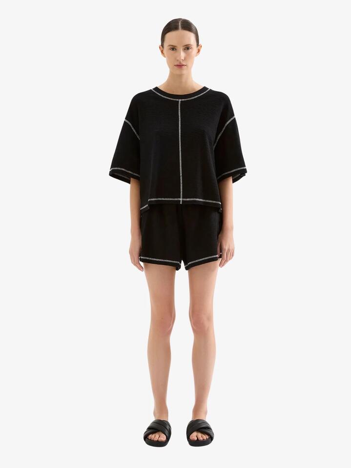 Image of a model wearing Shorts. Productname: Nude Lucy Sutton Shorts in Black colour by brand - Nude Lucy