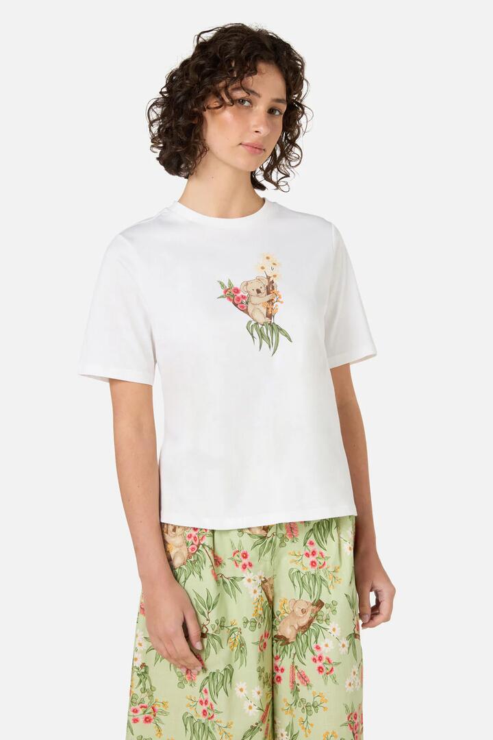 Image of a model wearing Tops. Productname: Koala Print Relaxed Tee in Cream colour by brand - Princess Highway