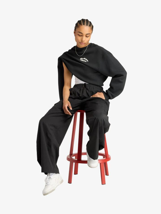 Image of a model wearing Pants. Productname: New Balance Woven Cargo Pant in Black colour by brand - New Balance