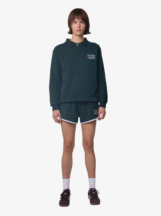 Image of a model wearing Shorts. Productname: West Hollywood Sweat Club American Sportswear Scalloped Sweat Shorts in Green/White colour by brand - West Hollywood Sweat Club