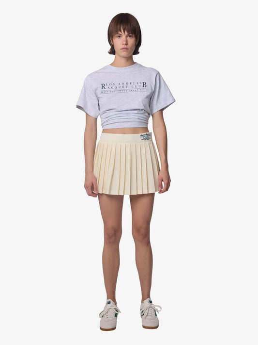 Image of a model wearing Skirts. Productname: West Hollywood Sweat Club American Sportswear Pleated Skirt in CREAM colour by brand - West Hollywood Sweat Club