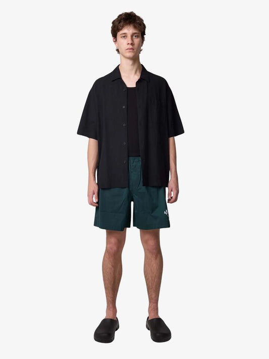 Image of a model wearing Shorts. Productname: Article One Wolfpack Swim Trunks in Forest colour by brand - Article One