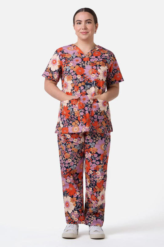 Image of a model wearing Uniforms & Workwear. Productname: Sunny Floral Scrub Set in Navy colour by brand - Scrubs With Love