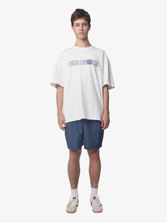 Image of a model wearing Tops. Productname: Deus Big World Tee in Vintage White colour by brand - Deus