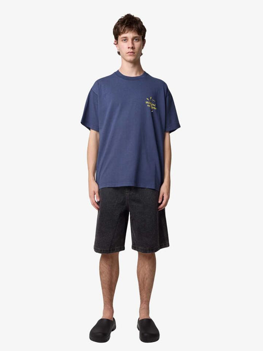 Image of a model wearing Tops. Productname: Weekend Cartel Worship Tee in NAVY colour by brand - Weekend Cartel