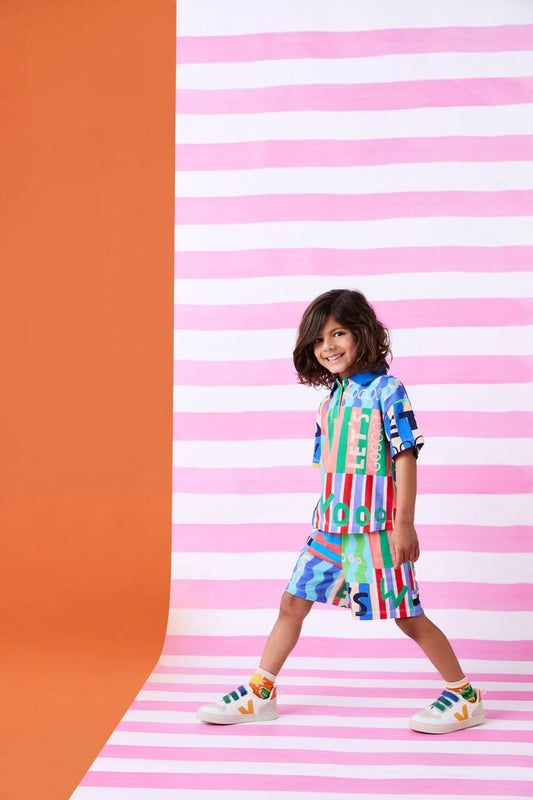 Image of a model wearing Tops. Product name - Woohoo Stripe Kids Polo Top in Multi colour by brand - Gorman