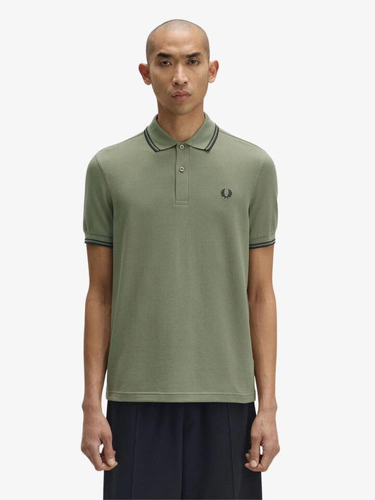 Image of a model wearing Tops. Productname: Fred Perry The Twin Tipped Fred Perry Shirt in Laurel Wreath Green colour by brand - Fred Perry