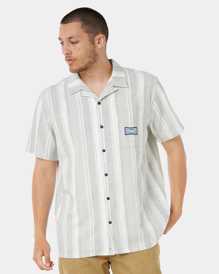 Image of a model wearing Tops. Productname: rip Curl - Mens Mod Cali Stripe Short Sleeve Shirt - Bluefin - in Bluefin colour by brand - rip Curl