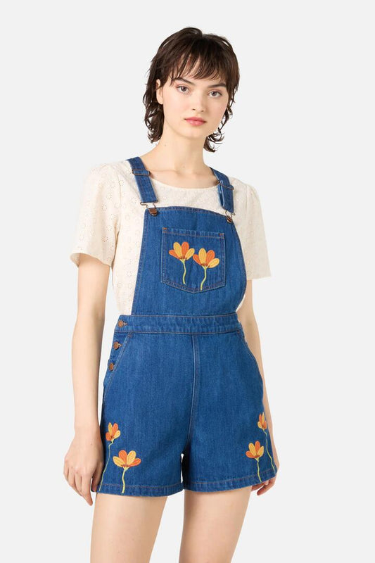 Image of a model wearing Pants. Productname: Lulu Embroidered Short Overall in Blue Denim colour by brand - Princess Highway