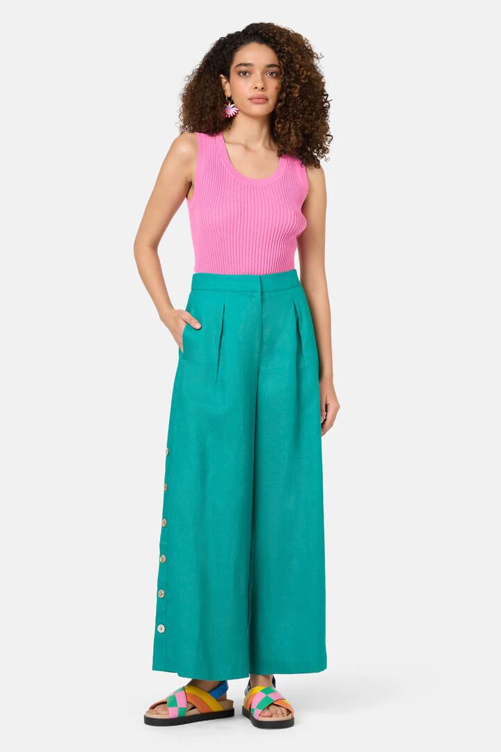 Image of a model wearing Skirts. Product name - Jade Side Button Skort in Green colour by brand - Gorman