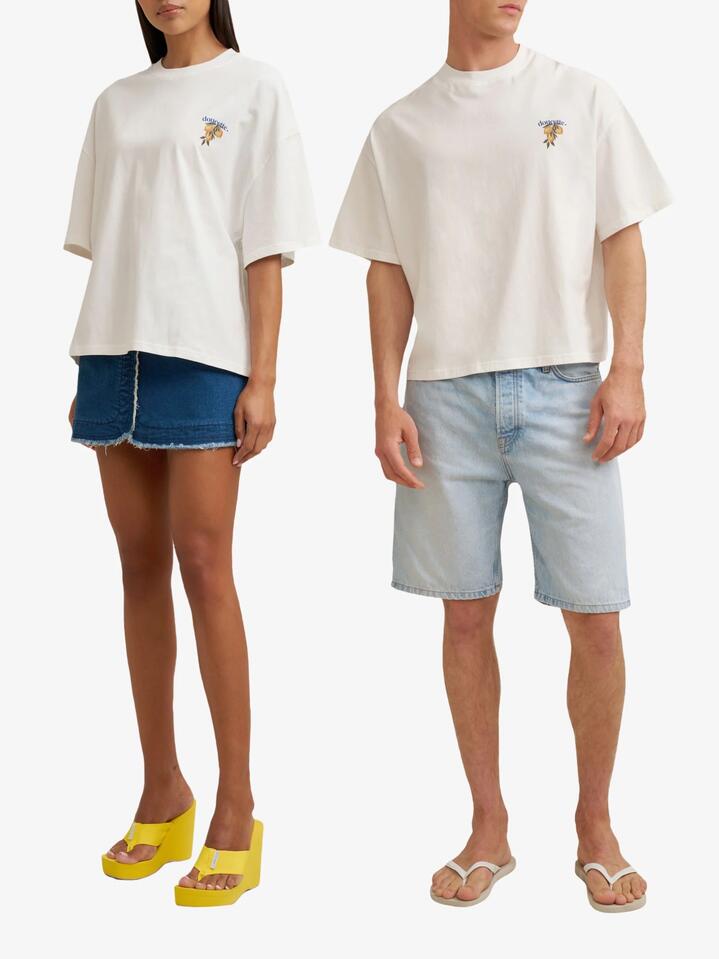 Image of a model wearing Tops. Productname: Doucette Unisex Lemonata Compact Tee in Ivory colour by brand - Doucette