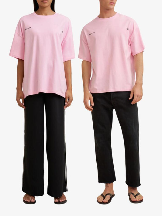 Image of a model wearing Tops. Productname: Doucette Unisex Freedom Box Tee in Pink Green colour by brand - Doucette