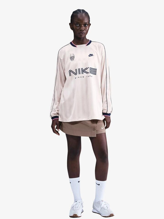 Image of a model wearing Tops. Productname: Nike Women's NSW Long-Sleeve Jersey Top in Silt Red/Midnight Navy colour by brand - Nike