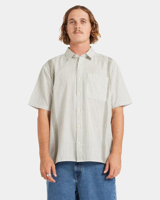 Image of a model wearing Tops. Productname: Volcom Mens Irving Short Sleeve Shirt Off White - in Off White colour by brand - Volcom