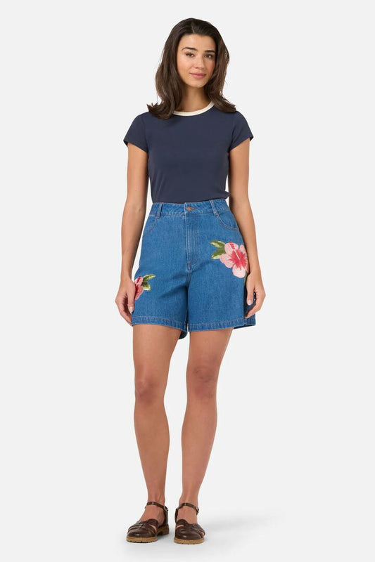 Image of a model wearing Shorts. Product name - Hibiscus Embroidered Denim Short in Blue Denim colour by brand - Princess Highway