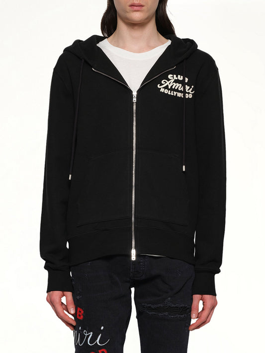 Image of a model wearing Outerwear. Product name - Club Amiri Zip Hoodie in Black colour by brand - AMIRI