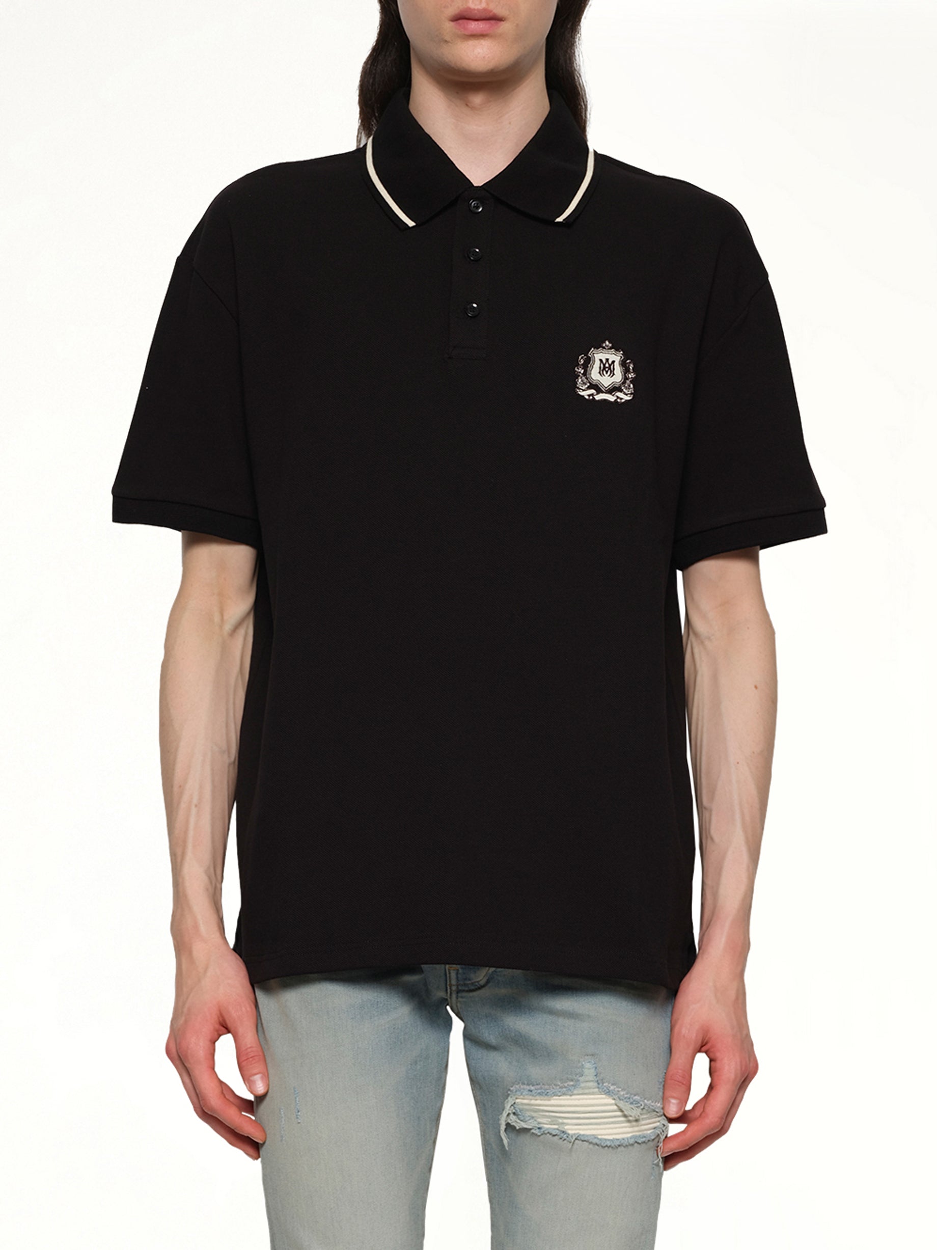 Image of a model wearing Tops. Productname: AMIRI MA Crest Polo in BLACK colour by brand - AMIRI